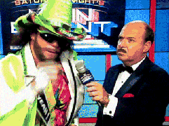 A wrestler shouting into an interviewer's microphone