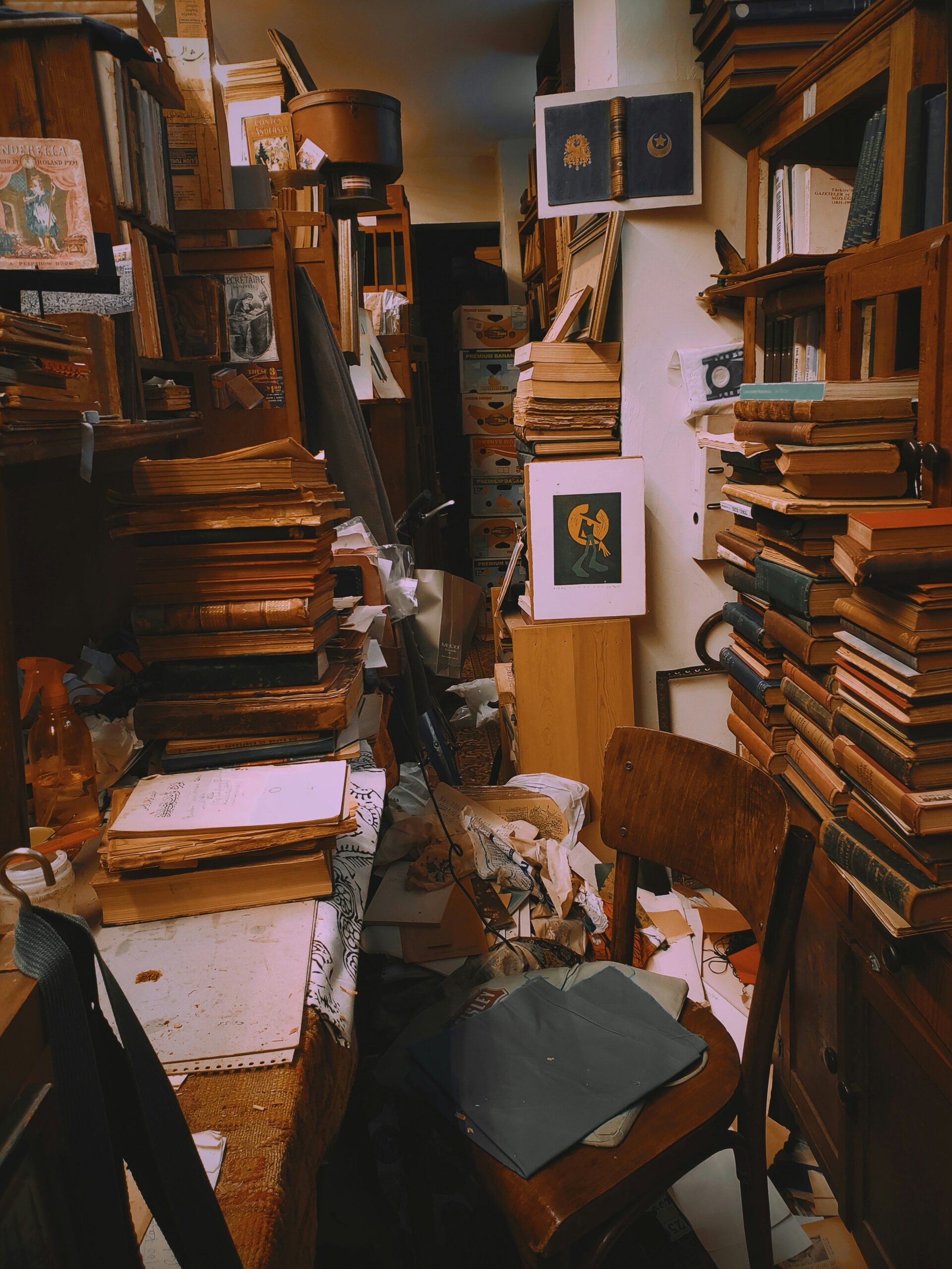 A cluttered desk buried in books and papers