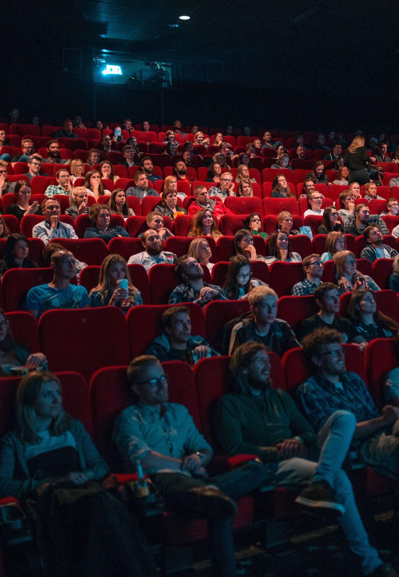 A packed movie theater audience